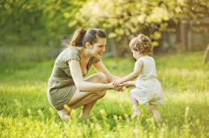 mom holding toddler hands