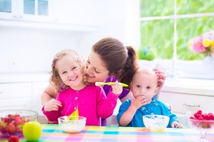 Mother and kids having breakfast